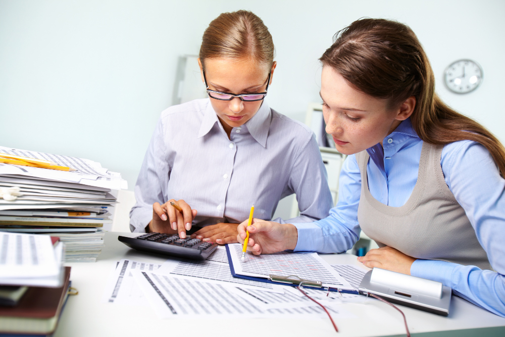 deux jeunes femmes qui travaillent ensemble sur un projet de comptabilité d'entreprise