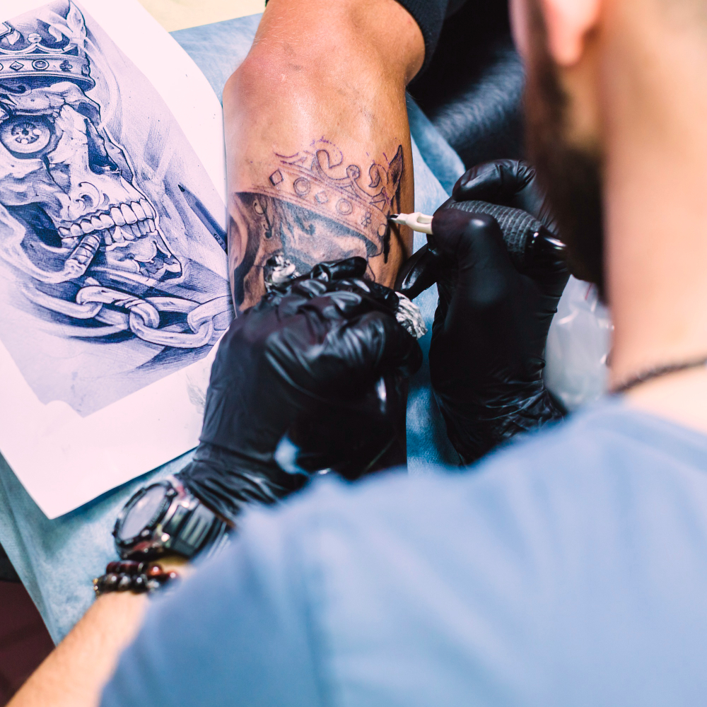 un tatoueur en pleine séance de tatouage